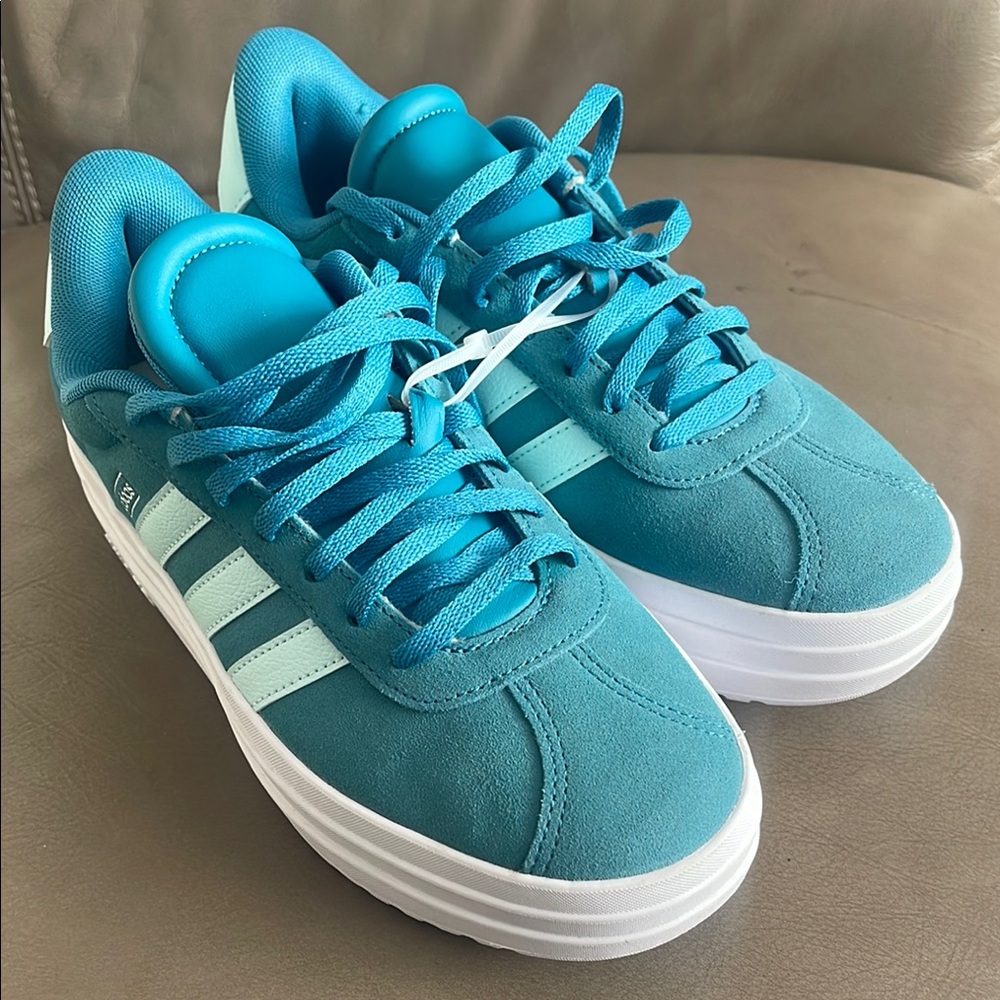 Adidas Teal Sneakers with lt blue Stripes.  Suede New without tag. It is unused
